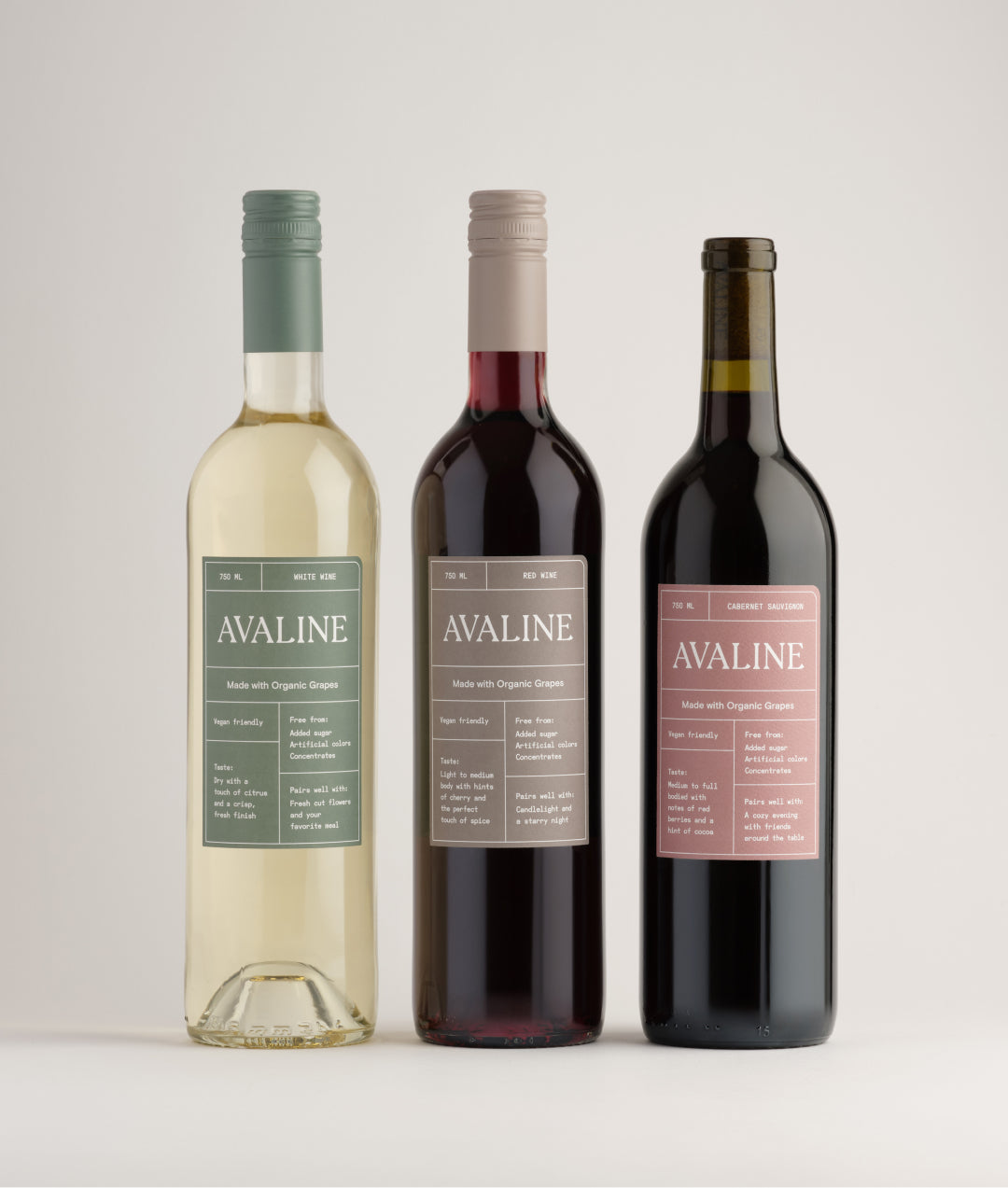 A lineup of wine bottles featuring Avaline White, Red, and Cabernet Sauvignon against a white background.