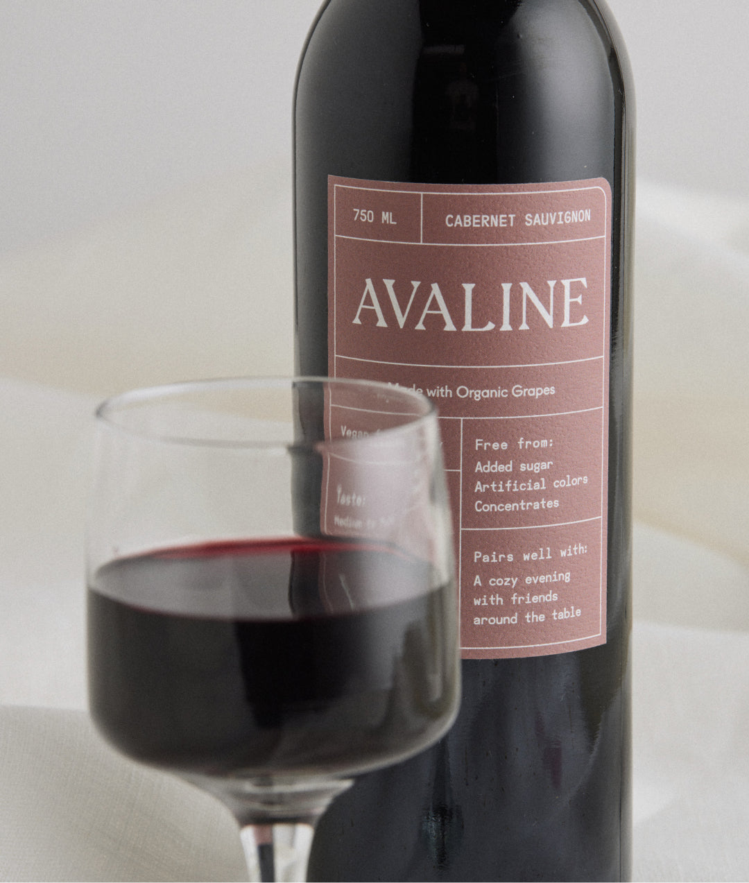 A close up photo of Avaline Cabernet Sauvignon wine bottle and wine in a glass